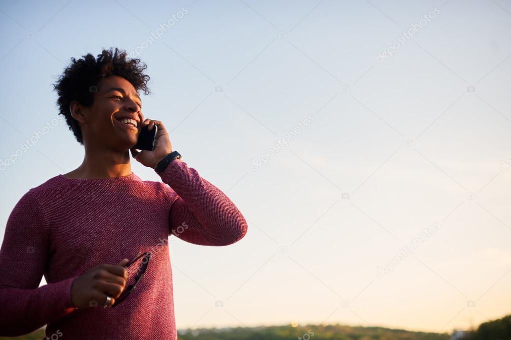 Happy man talking on mobile phone