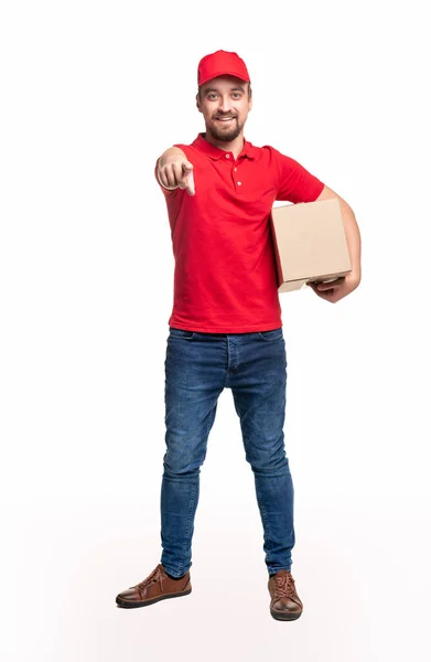 Positive delivery man pointing at camera — Stock Photo, Image