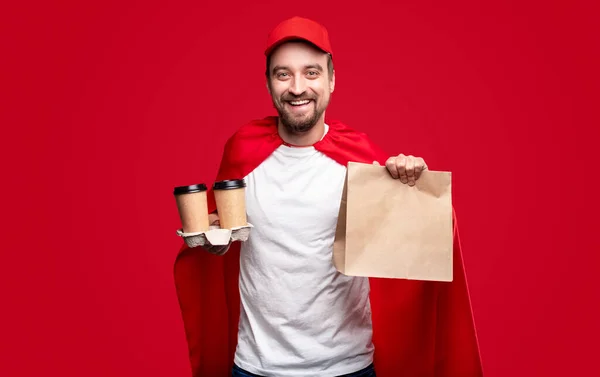 Cheerful male superhero delivering food — Stock Photo, Image