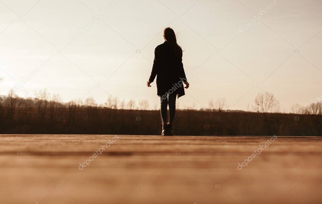 Lonely woman walking in autumn nature