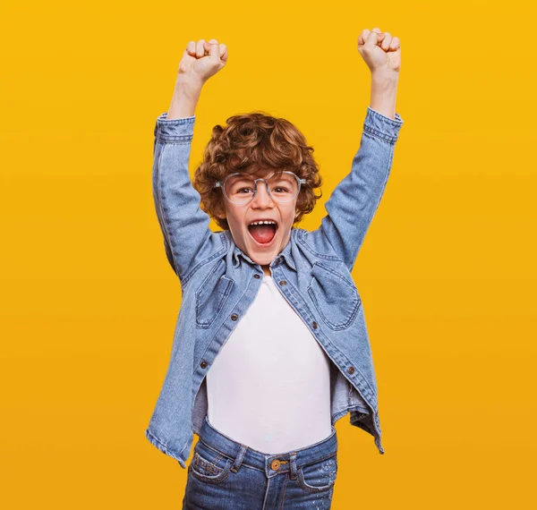 Задоволений хлопчик святкує перемогу в студії — стокове фото