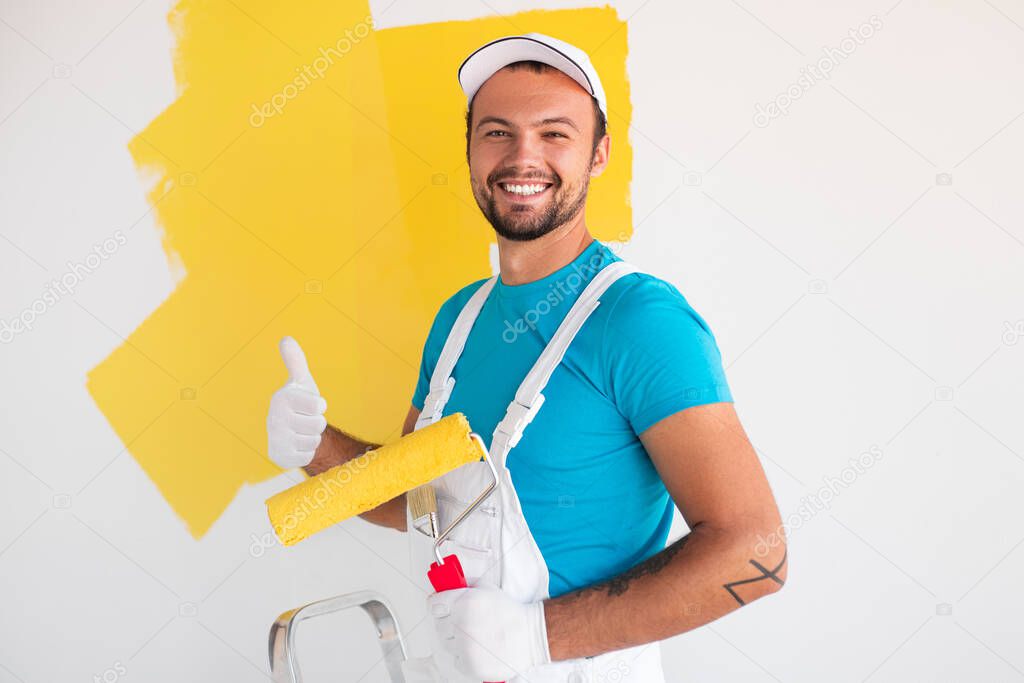 Happy painter gesturing thumb up