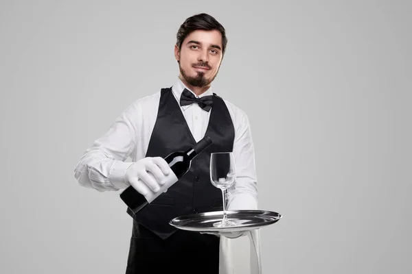 Elegant waiter serving wine in restaurant — Stock Photo, Image