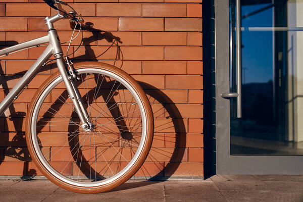 Велосипед припаркован возле кирпичного здания