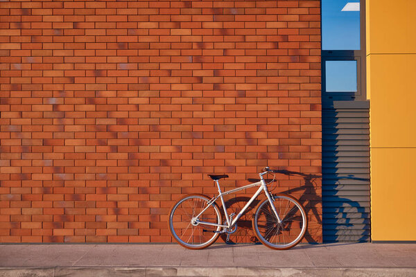 Bicycle parked near modern city building