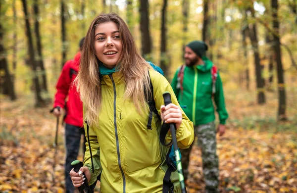 Mujer activa senderismo en el bosque con amigos — Foto de Stock