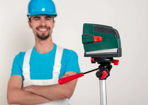 Laser level near male contractor — Stock Photo, Image