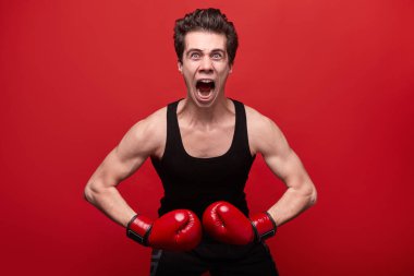 Boks eldivenli, sinirli bir savaşçı.