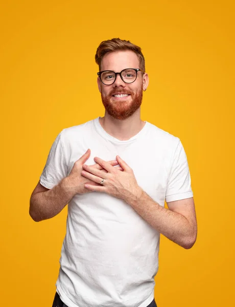 Lächelnder Mann hält die Hände am Herzen — Stockfoto