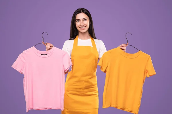 Alegre ama de casa elegir entre camisetas — Foto de Stock