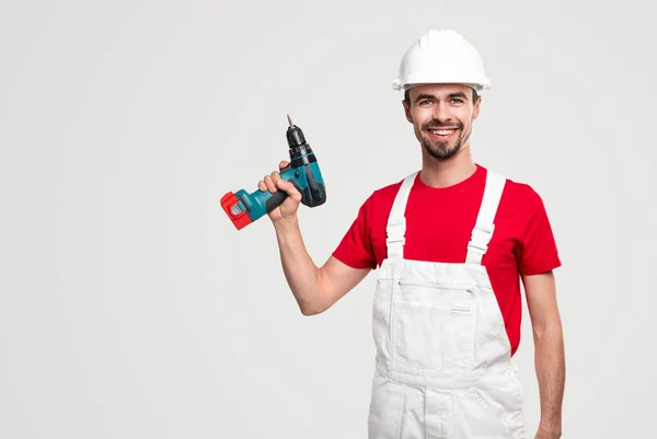 Cheerful handyman with electric screwdriver — Stock Photo, Image