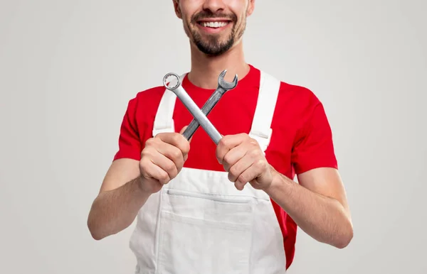 Cheerful mechanic with spanner wrenches — Stock Photo, Image