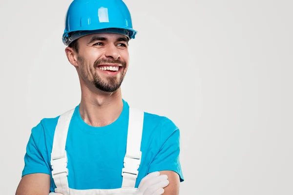 Smiling confident builder in blue uniform — Stock Photo, Image