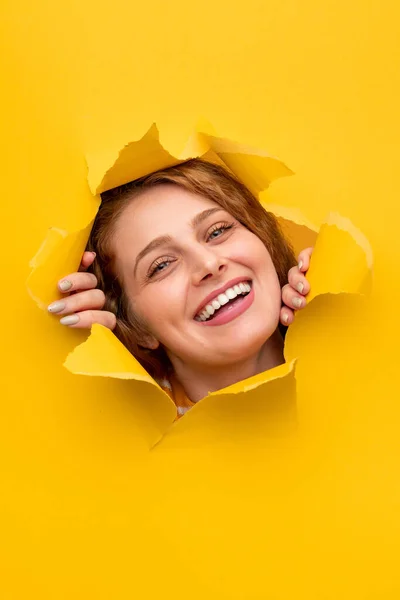 Mutlu kadın yırtık kağıt ve gülümseme — Stok fotoğraf