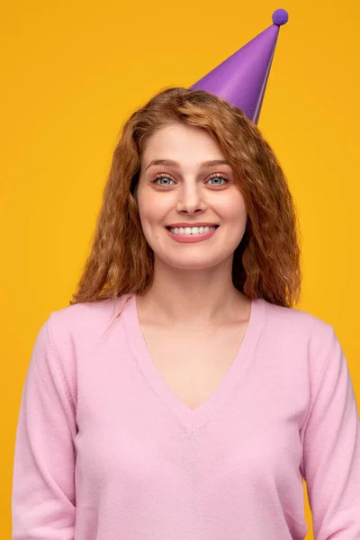 Joyful redhead woman in party hat — Stock Photo, Image