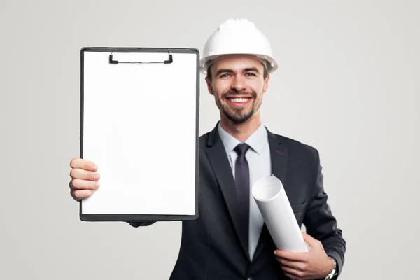 Cheerful engineer showing blank clipboard — Stock Photo, Image