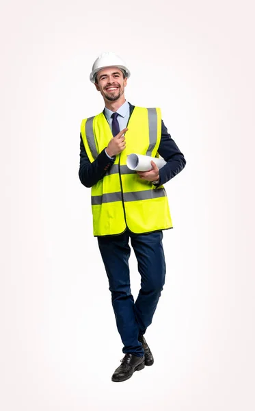 Happy contractor in hardhat and vest pointing away — Stock Photo, Image