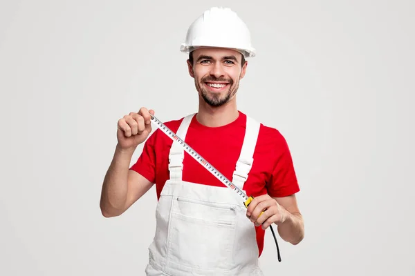 Cheerful handyman with measuring tape — Stock Photo, Image