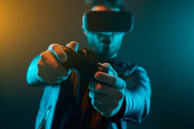 Oyun oynayan joystick ve VR gözlüklü adam.