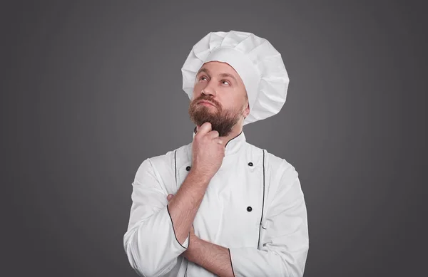 Pensive samec kuchař v uniformě a klobouku — Stock fotografie