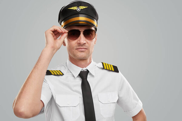 Confident pilot in uniform and sunglasses
