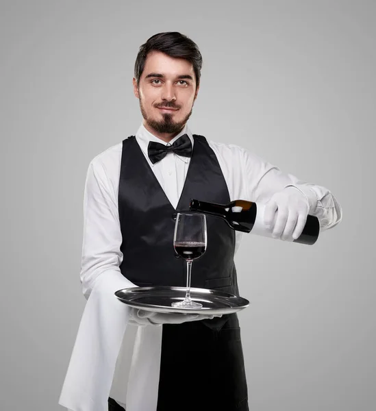 Elegant waiter serving wine in restaurant — Stock Photo, Image