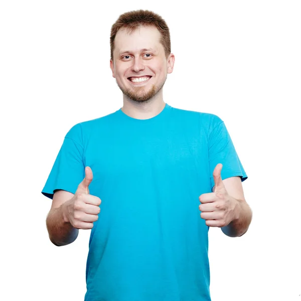 Usmívající se mladý muž ukazující palce nahoru — Stock fotografie
