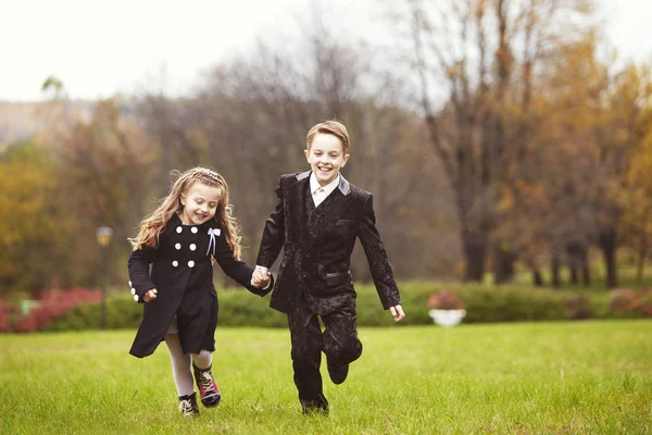 Brother and sister kids running in park — Stock Photo, Image