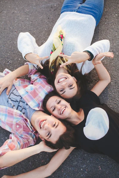 Top view of friends lying down and smiling — 图库照片