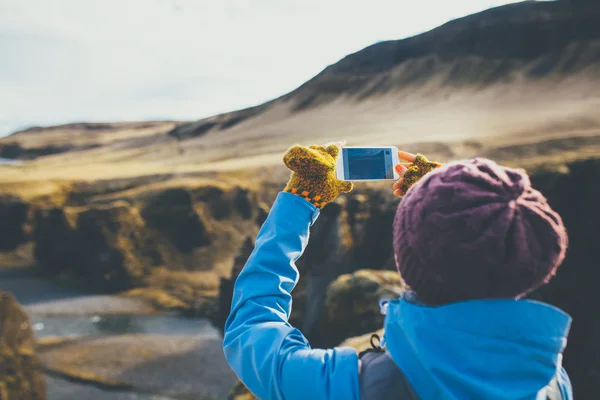 Mulher usando roupas de inverno tirando fotos na Islândia — Fotografia de Stock