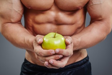 shirtless bodybuilder holding an apple clipart