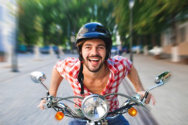 Yakışıklı genç sürme scooter gülümseyen