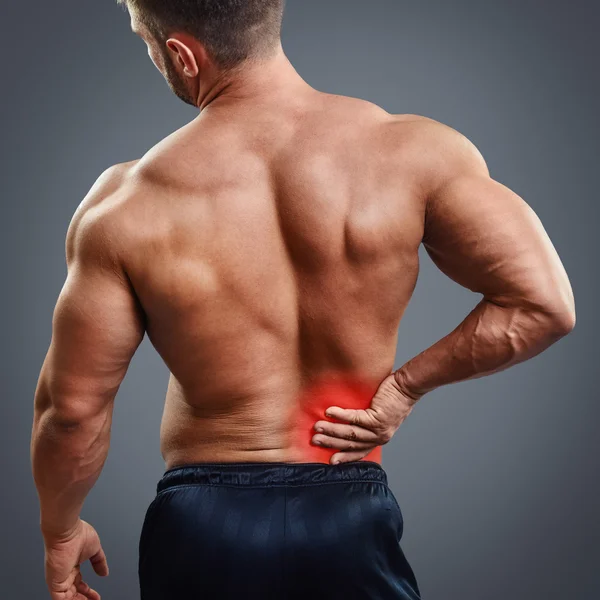 Ahtletic muscle man back pain — Stock Photo, Image