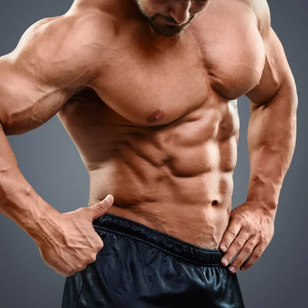 Man with torso muscles showing ok sign. — Stock Photo, Image