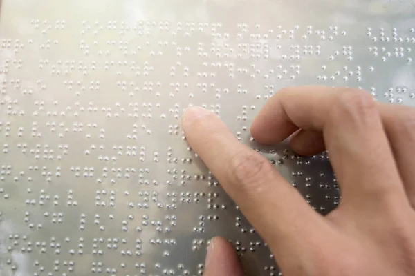 Close up finger touch to braille Code