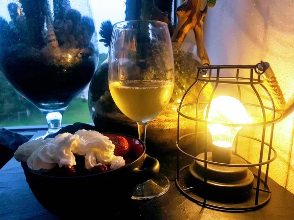 A glass of white wine in a warm summer evening