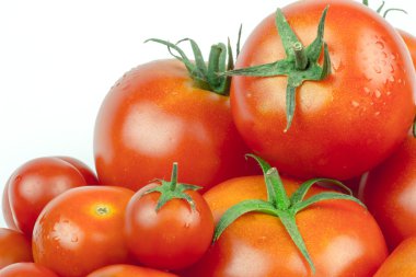 Tomatoes. Whole and a half isolated on white clipart