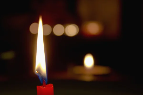 Red candle burning in the dark — Stock Photo, Image