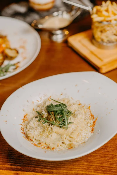 Macaroni and cheese with grated parmesan cheese on top