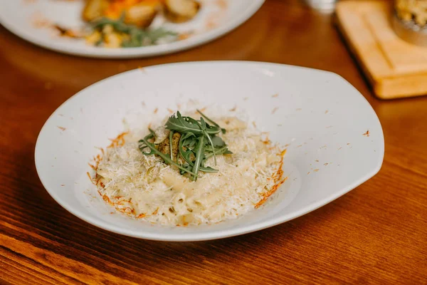 Macaroni and cheese with grated parmesan cheese on top