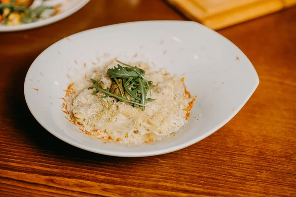 Macaroni and cheese with grated parmesan cheese on top