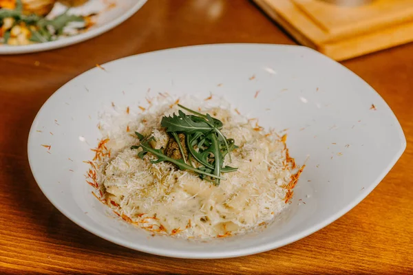 Macaroni and cheese with grated parmesan cheese on top