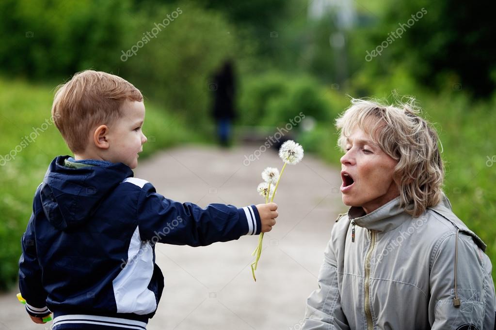 Мальчик и женщина с одуванчиком стоковая фотография © mme