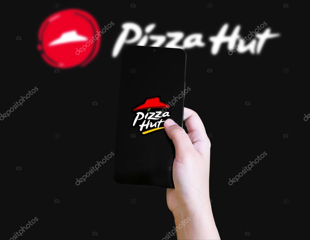 Pizza hut mobile app for ordering food online, illustrative editorial background.