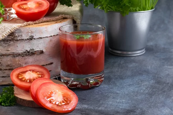 Tomato juice. Tomato juice in glasses. Detox. Healthy eating. Healthy foods. Stand for still life in the form of a birch saw cut. Birch stump. High quality photo