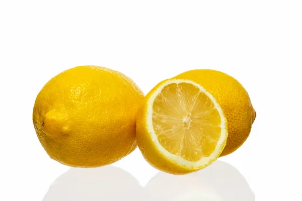 Lemons and half-lemon on a white background. Isolate on white. — Stock fotografie