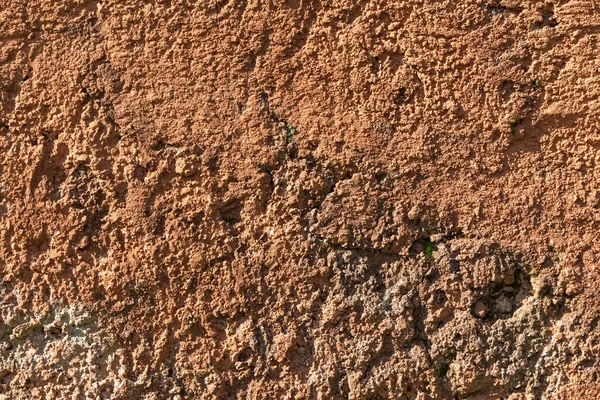 A reddish brown stone texture with a slight blur. Stone wall. — Stock Photo, Image