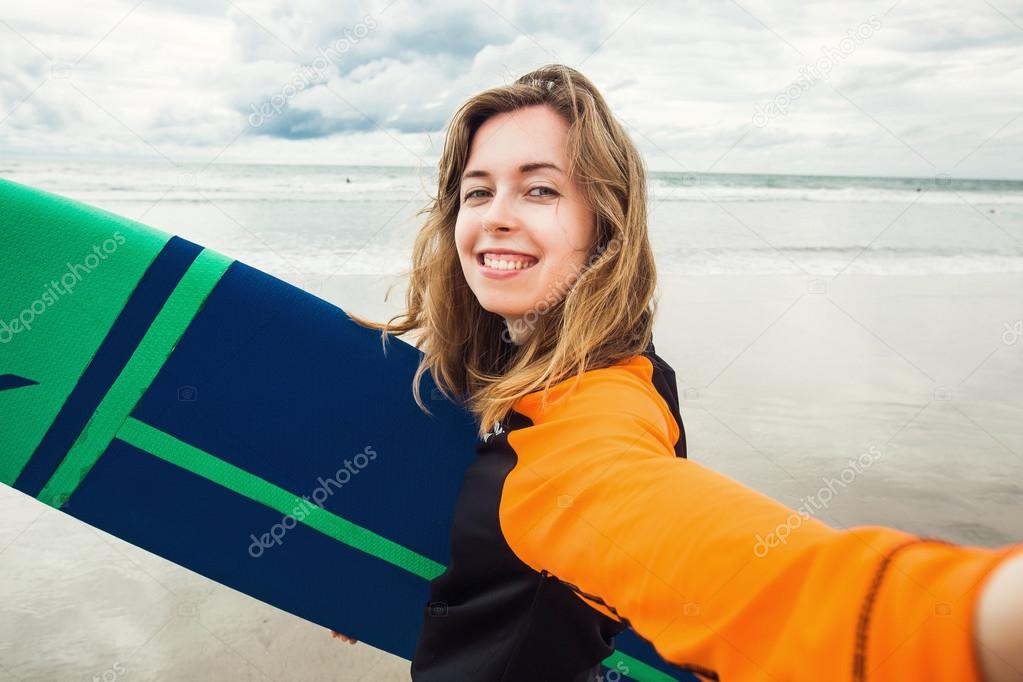 Surfer girl making selfie 