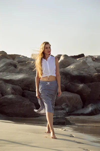 A young woman walking at the seaside