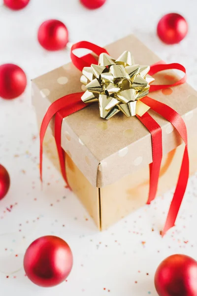 纸制礼品盒 红色缎带和金色蝴蝶结 红色圣诞球和五彩缤纷的白色背景 圣诞节或新年礼物 — 图库照片